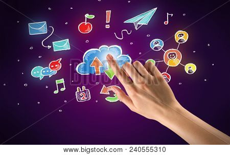Female hand toucing mixed media icons with purple background