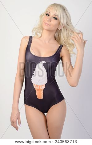 Beautiful Slimgirl In A Black Bathing Suit Positively Poses In Studio