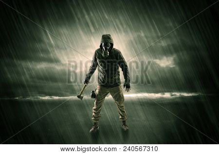 Terrorist in a stormy space with gas mask on his hand and weapons on his arm