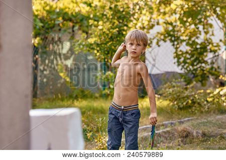 Concentrated Sporty Young Boy Training With Throwing Knife