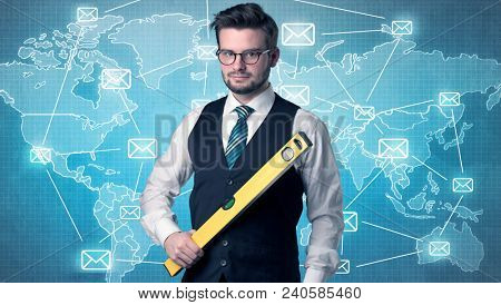 Businessman holding tool with global map graphic on the background