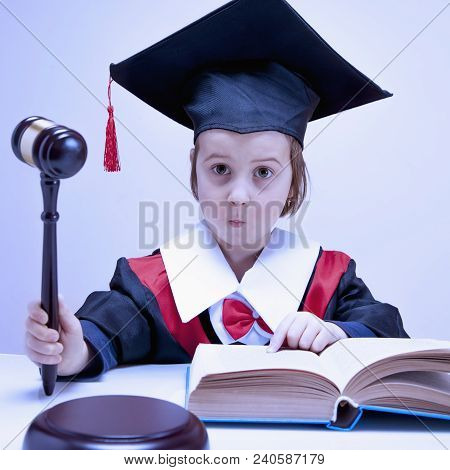 Very Funny Portrait Of Child Girl Judge (lawyer) Makes A Decision. Humorous Photo.