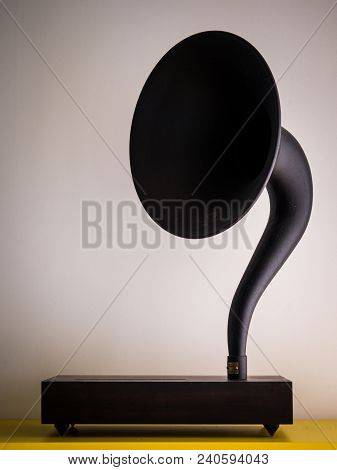 The Vintage Gramophone Stands In Front Of A White Wall Isolated