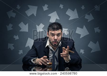 Drunk disappointed man sitting at table with arrows around