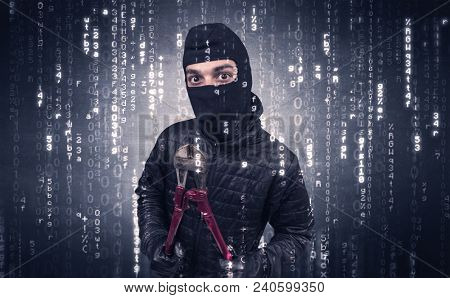 Burglar in action with encoded concept and his tools in his hand. 