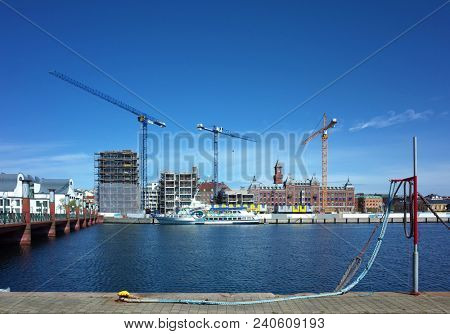 Helsingborg, Sweden - 04 May, 2018: Large construction site with several cranes building new complex at waterfront. Helsingborg is a port city located in southern Sweden on the shore of Oresund strait