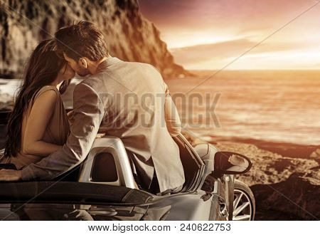 Attractive young cople kissing at sunset