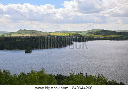 Machovo Jezero Lake With Doksy City On Background During Spring Windy Cloudy Weather When Viewed Fro