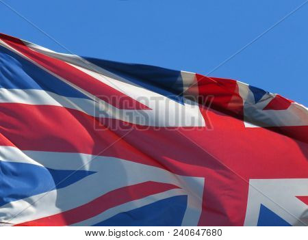 National Flag Of United Kingdom On In Front Of Blue Sky.