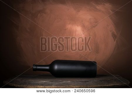 Red Wine Bottle On A Wooden Brown Background
