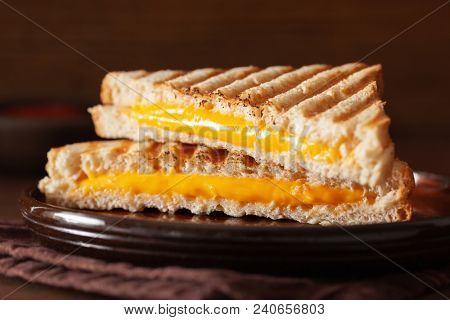 grilled cheese sandwich on rustic brown background