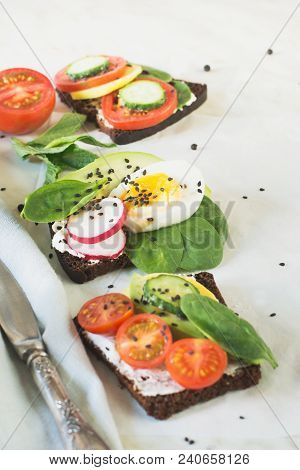 Summer Sandwiches With Vegetables, Eggs, Avocado, Tomato, Rye Bread On Light Marble Table. Appetizer