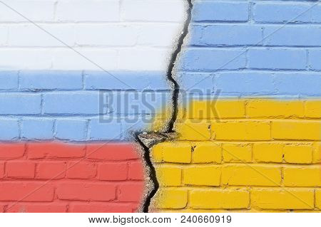 Ukraine And Russia Flag On Grunge Brick Wall