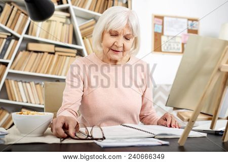 Lifetime Learner. Focused Senior Woman Studying While Staring Down