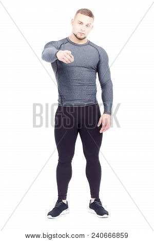 Portrait Of Handsome Well-muscled Gym Instructor In Sports Tights And Rashguard Posing On White Back