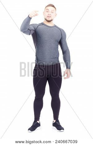 Portrait Of Handsome Well-muscled Gym Instructor In Sports Tights And Rashguard Posing On White Back