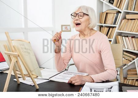 I Get It. Joyful Senior Woman Studying While Shouting
