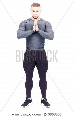 Portrait Of Handsome Well-muscled Gym Instructor In Sports Tights And Rashguard Posing On White Back