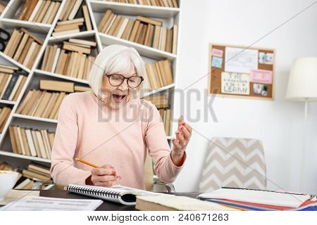 Unexpected Solution. Jovial Mature Woman Shouting While Doing Task