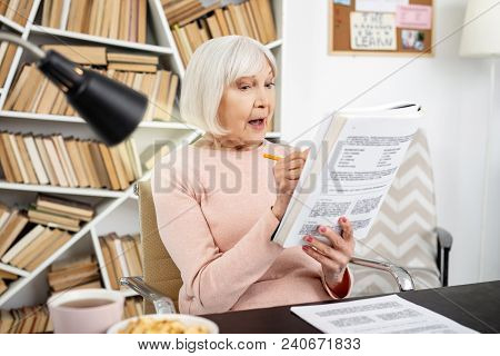 Learning Process. Surprised Mature Woman Opening Mouth While Doing Task