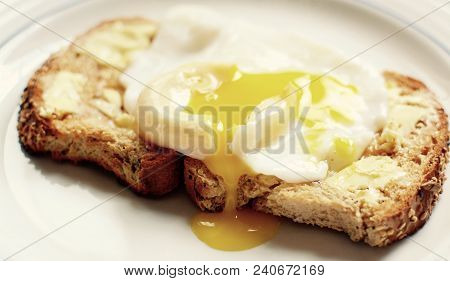Runny Poached Egg On Brown Buttered Toast - Filter Applied