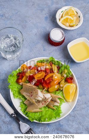 Fish Fillet With Raw Vegetables And Lemon In A Dish On The Table. Selective Focus.