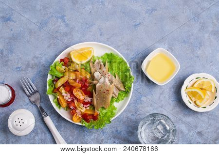 Fish Fillet With Raw Vegetables And Lemon In A Dish On The Table. Selective Focus.