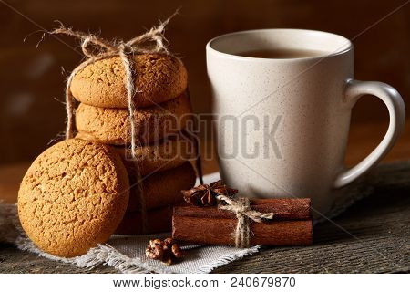 Traditional Christmas Tea Concept With A Cup Of Hot Tea, A Large Set Of Cookies On A Homespun Napkin