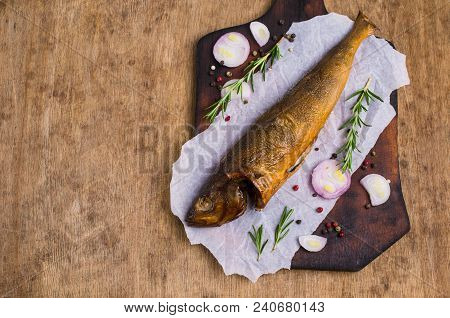 Smoked Whole Fish With Spices On Wooden Background. Selective Focus.