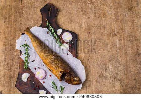Smoked Whole Fish With Spices On Wooden Background. Selective Focus.