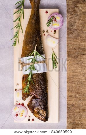 Smoked Whole Fish With Spices On Wooden Background. Selective Focus.