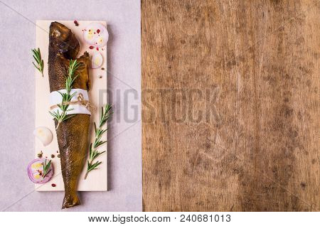Smoked Whole Fish With Spices On Wooden Background. Selective Focus.