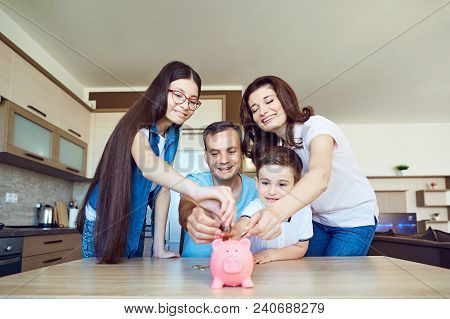 Happy Family With Pig Piggy In The Room. The Concept Of Saving In The Family.