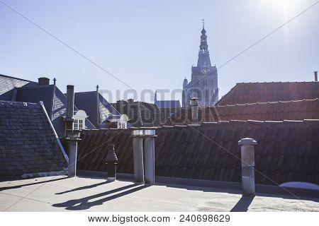 Rooftops In The Netherlands With Sunset And A Historic Church