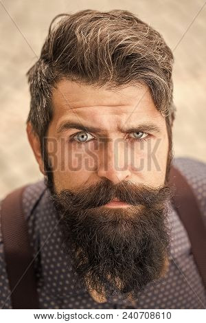 Handsome Senior Stylish Man With Black Hair And Long Lush Beard In Blue Shirt Standing Outdoor On Wh