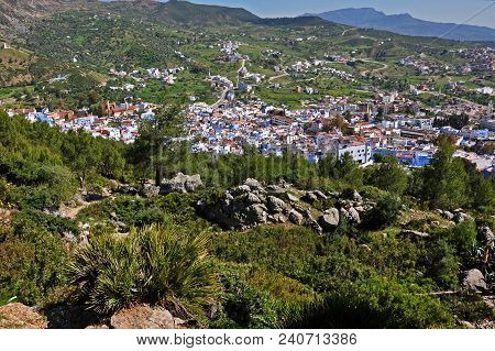 The Historic City Of Chefchaouen From Above During A Sunny Day, Lying Underneath Rif Mountains.
