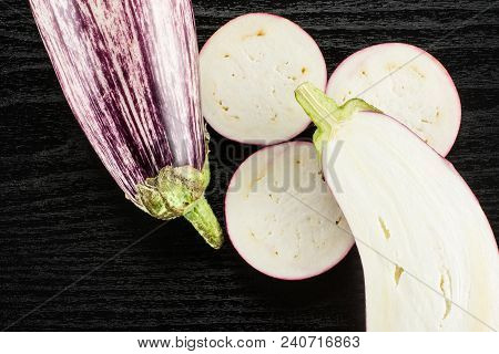 Striped Purple Eggplants Set Top View Isolated On Black Wood Background Whole One Half And Sliced Th