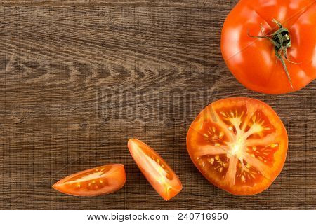 Red Tomato Collection Isolated On Brown Wood Background Top View One Whole One Section Half And Two 