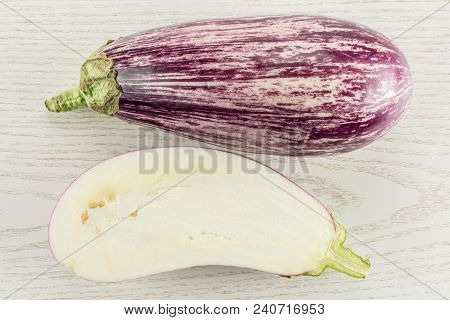Striped Purple Eggplant Collection Top View Isolated On Grey Wood Background One Whole And Sliced Se