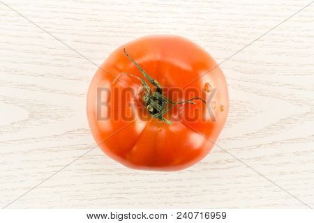 One Red Tomato Isolated On Grey Wood Background Top View