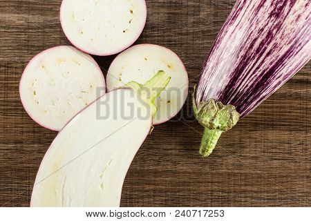 Striped Purple Eggplants Set Top View Isolated On Brown Wood Background Whole One Half And Sliced Th