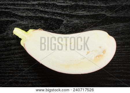 One Striped Purple Eggplant Half Top View Isolated On Black Wood Background Cross Section