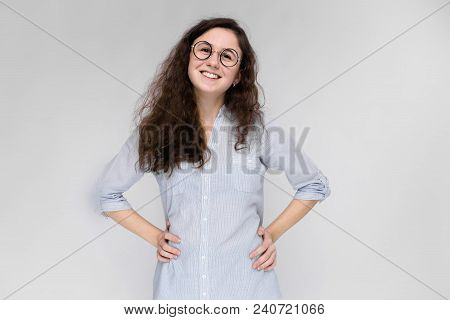 Young Girl Holds Her Hand Glasses. The Girl Is Smiling. The Girl Is Smiling.