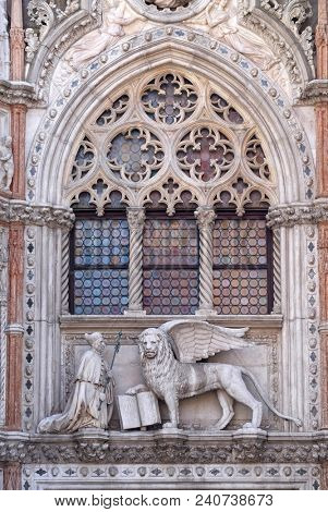VENICE, ITALY - MAY 28 : Detail of the Porta della Carta entrance to the Doge's Palace in Venice, Italy, depicting Doge Francesco Foscari kneeling before the Lion of St. Mark, on May 28, 2017.