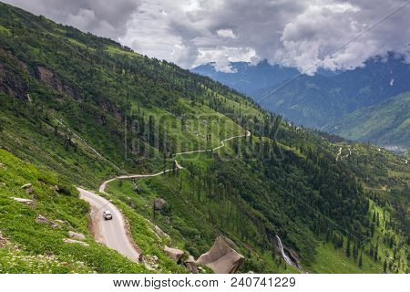 Road from Rohtang pass through the beautiful green Kullu valley in Himachal Pradesh state, India