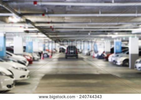 Cars Parked In The Parking Lot Blurred For Background.underground Parking Garage Area In Supermall.