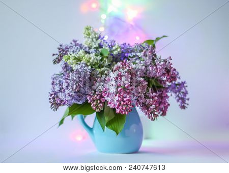 Beautiful Bouquet Of Fragrant Purple Flowers In Blue Ceramics Vase On Light Background With Festive 