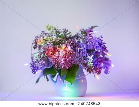Beautiful Bouquet Of Fragrant Purple Flowers In Blue Ceramics Vase On Light Background With Festive 