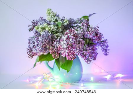 Beautiful Bouquet Of Fragrant Purple Flowers In Blue Ceramics Vase On Light Background With Festive 