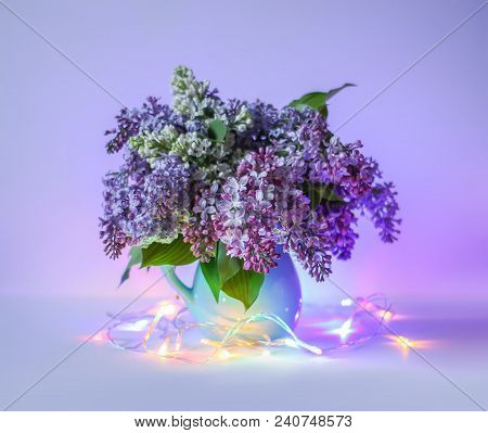 Beautiful Bouquet Of Fragrant Purple Flowers In Blue Ceramics Vase On Light Background With Festive 